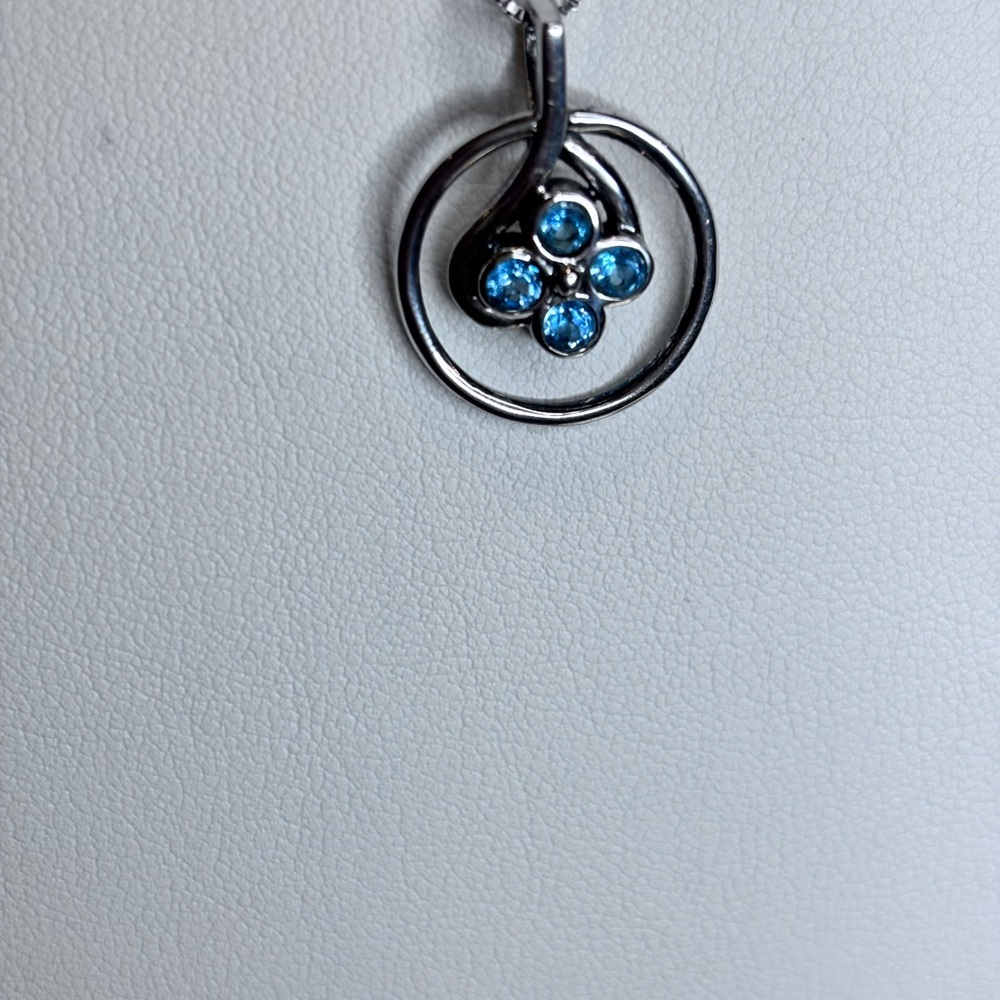 Elegant Silver Pendant with Blue topaz Accents